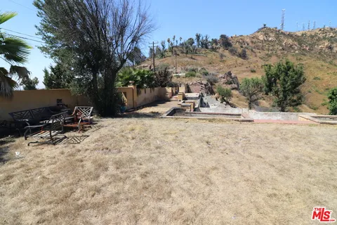 a view of a backyard of the house