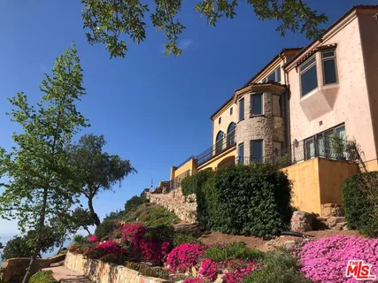 a terrace with outdoor seating and city view