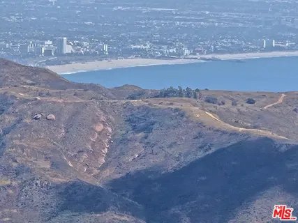 a aerial view of a house with a big yard and large trees