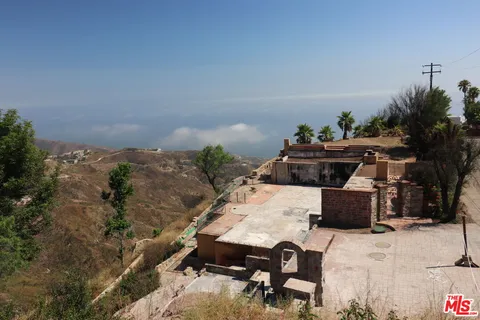 a view of a backyard with sitting area