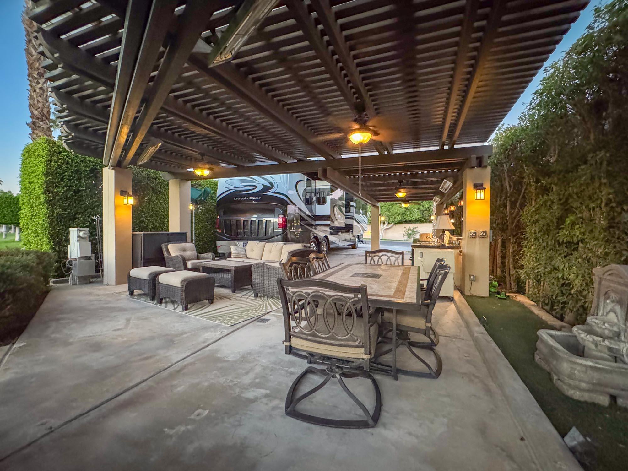 80394 Ave 48, Unit 244 Indio, CA 92201 - Photo 12 of 25 a view of a patio with table and chairs with a barbeque grill and plants