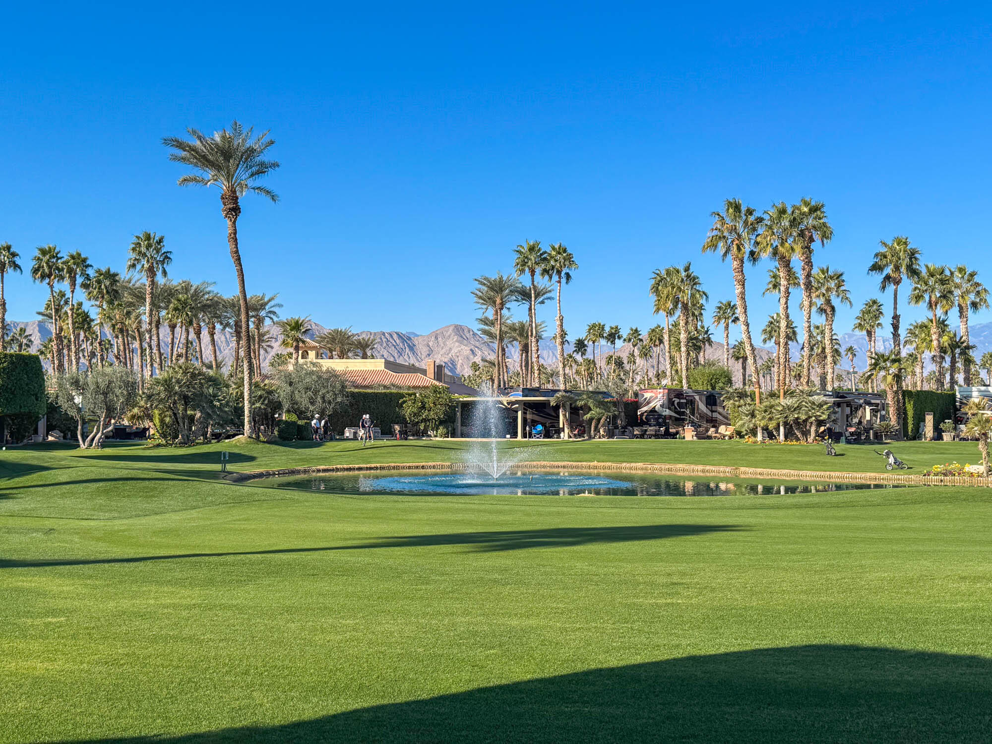 80394 Ave 48, Unit 244 Indio, CA 92201 - Photo 2 of 25 a view of a big building with a big yard and palm trees