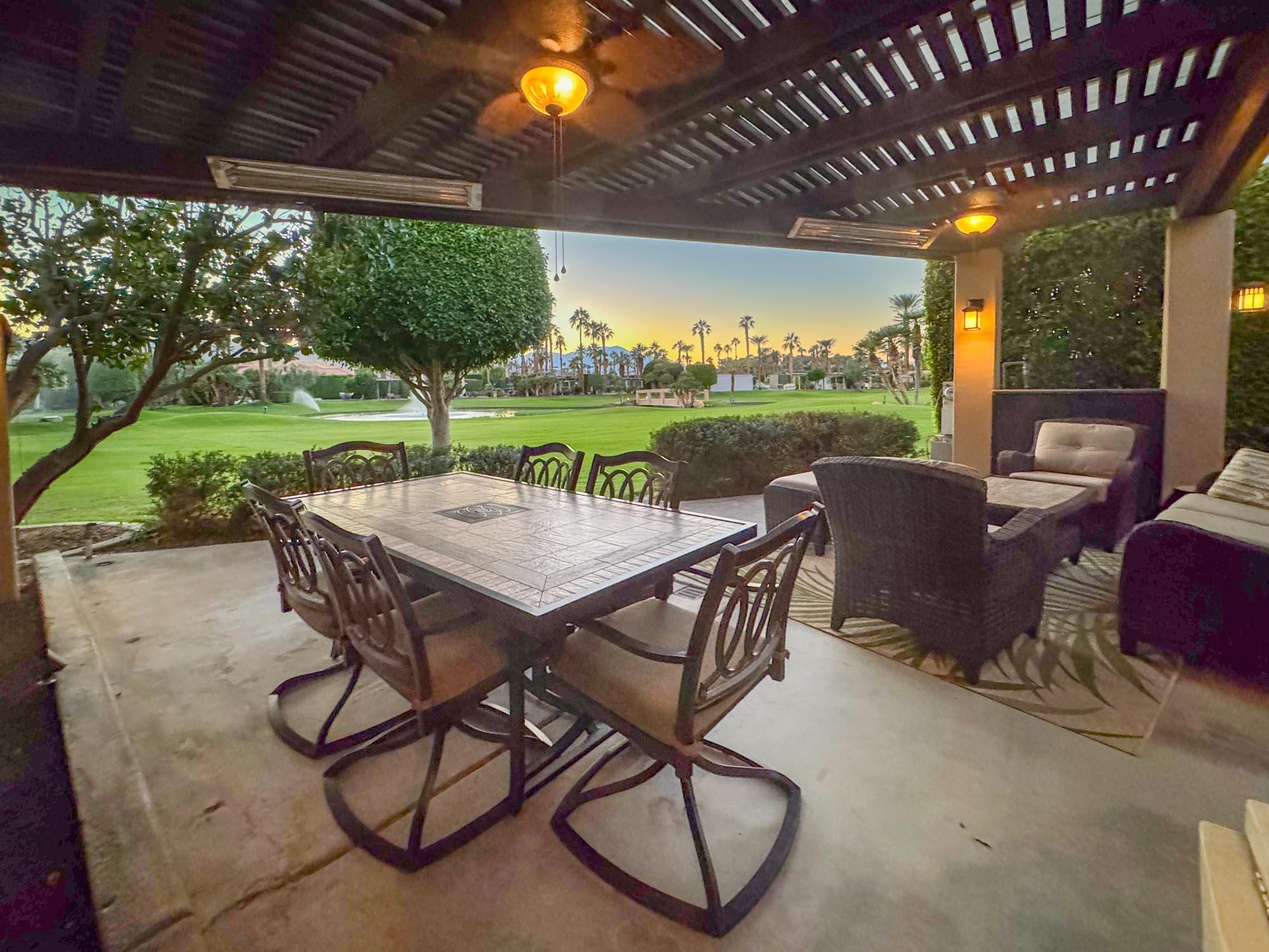 80394 Ave 48, Unit 244 Indio, CA 92201 - Photo 10 of 25 a view of a patio with a table chairs and a backyard