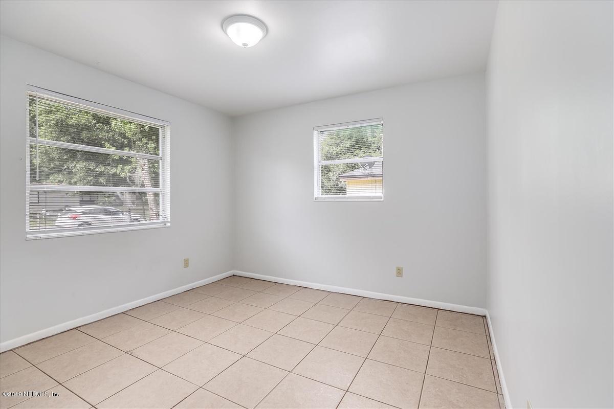 7521 Proxima Road Jacksonville, FL 32210 - Photo 8 of 10 an empty room with windows
