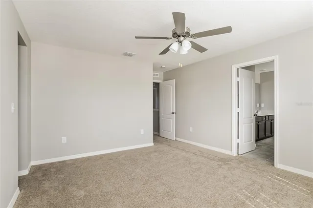 a view of a livingroom with a ceiling fan and entryway