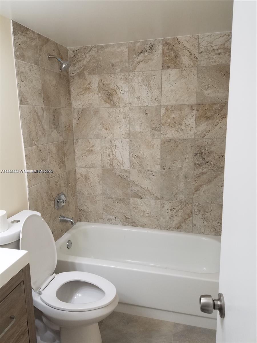 3410 Foxcroft Road, Unit 207 Miramar, FL 33025 - Photo 9 of 18 a bathroom with a toilet and a bath tub
