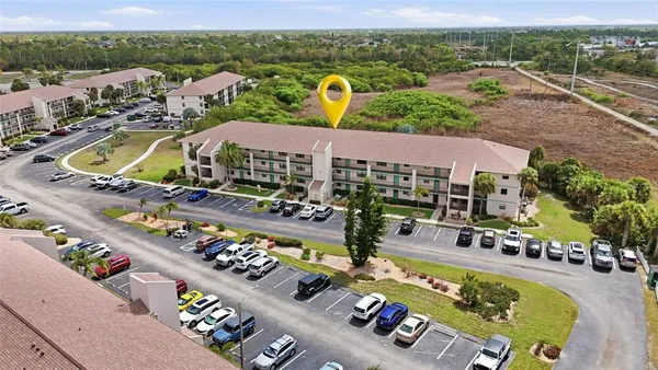 a view of a swimming pool with a patio and a yard