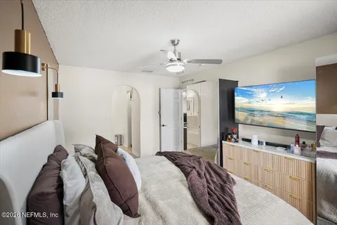 a bedroom with bed and a flat screen tv