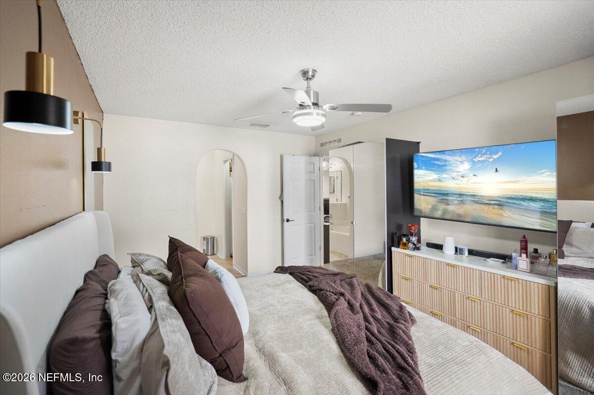 10310 Woodley Point Road Jacksonville, FL 32218 - Photo 15 of 30 a bedroom with bed and a flat screen tv