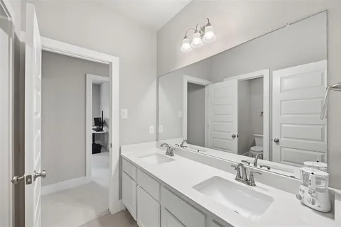 a bathroom with 2 sink and a mirror