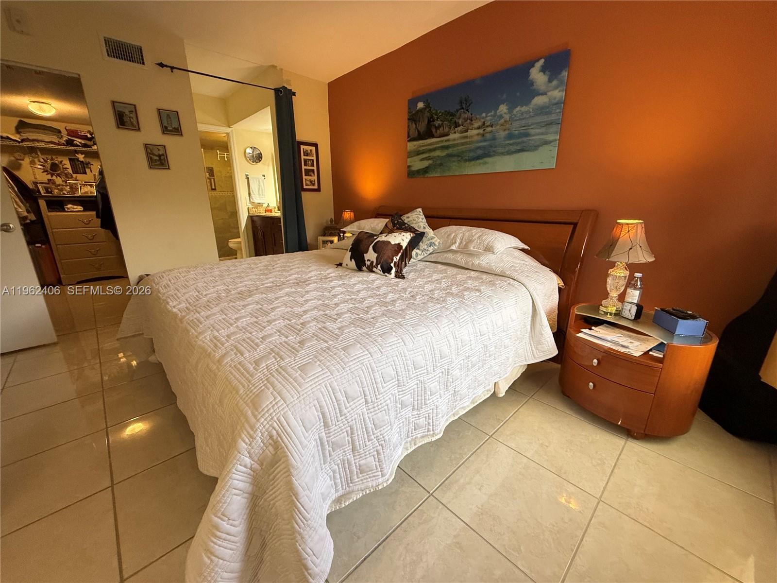 351 Club Circle, Unit 102 Boca Raton, FL 33487 - Photo 20 of 34 a bed sitting in a bedroom next to a window