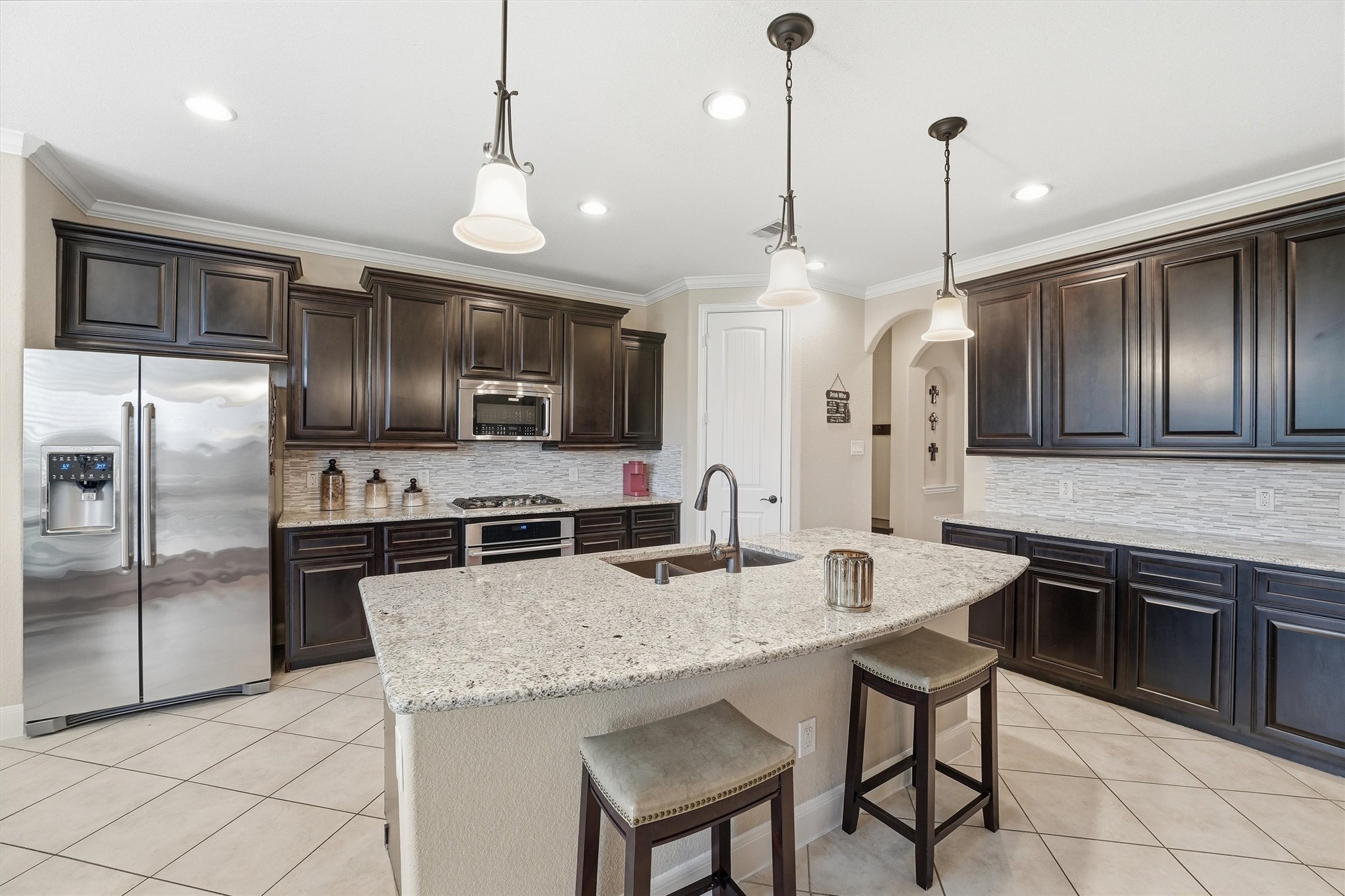 12506 Northpointe Ridge Lane Tomball, TX 77377 - Photo 8 of 31 a kitchen with stainless steel appliances granite countertop a sink a stove a refrigerator cabinets and chairs