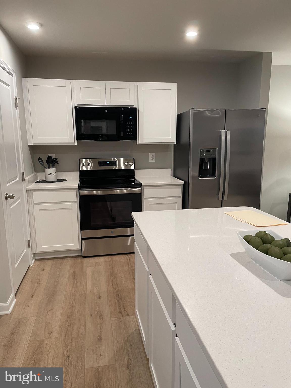 2640 High Point Drive Culpeper, VA 22701 - Photo 6 of 27 a kitchen with stainless steel appliances a stove a microwave and white cabinets