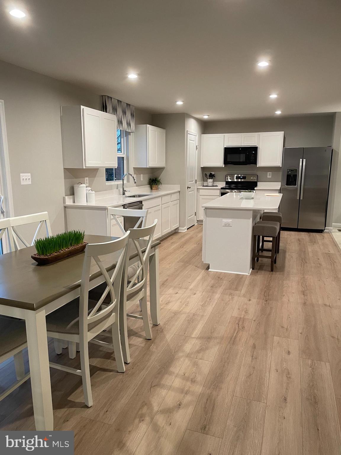 2640 High Point Drive Culpeper, VA 22701 - Photo 9 of 27 a kitchen with stainless steel appliances kitchen island granite countertop a table chairs sink and cabinets