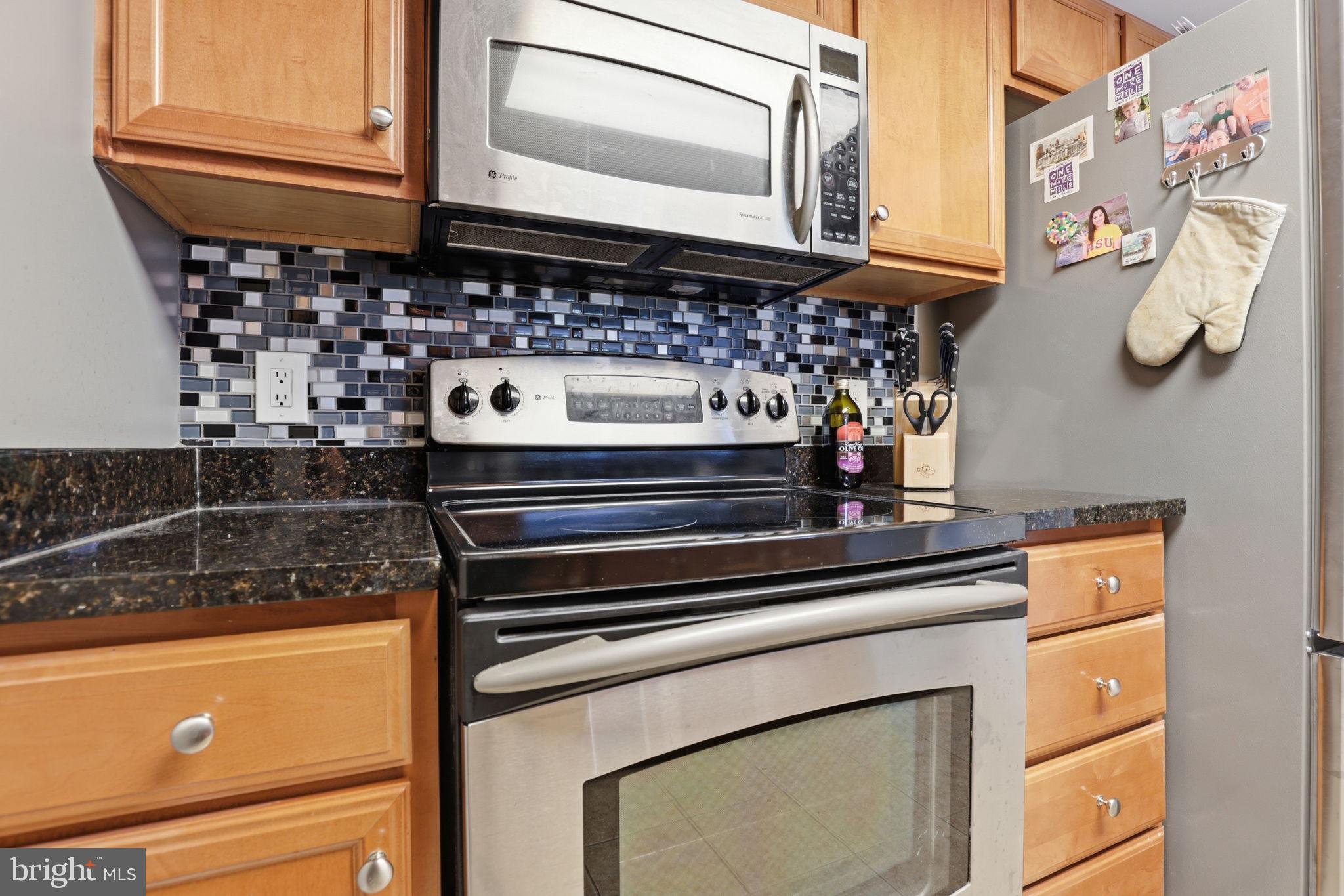 11800 Sunset Hills Road, Unit 218 Reston, VA 20190 - Photo 26 of 38 a kitchen with a stove and a microwave