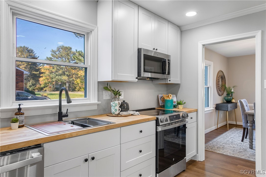 12079 Sunset Drive Ashland, VA 23005 - Photo 12 of 27 a kitchen with stainless steel appliances granite countertop a sink a stove and cabinets