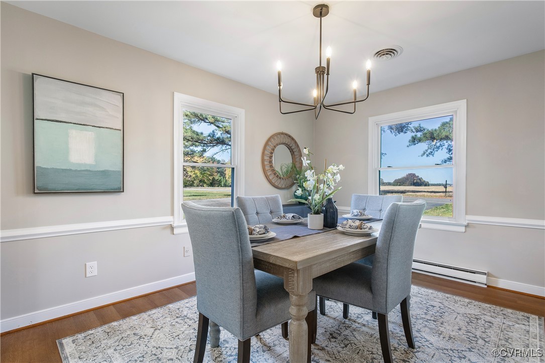12079 Sunset Drive Ashland, VA 23005 - Photo 14 of 27 a dining room with furniture a rug and a chandelier