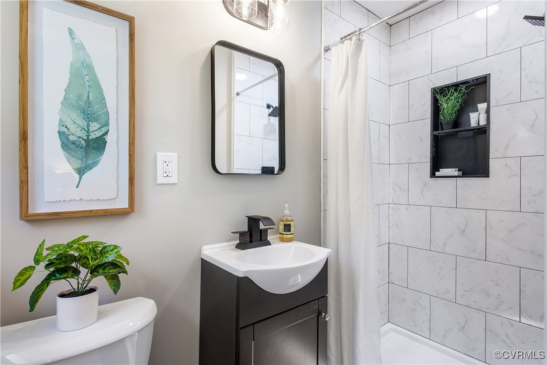 12079 Sunset Drive Ashland, VA 23005 - Photo 17 of 27 a bathroom with a sink a mirror and a potted plant