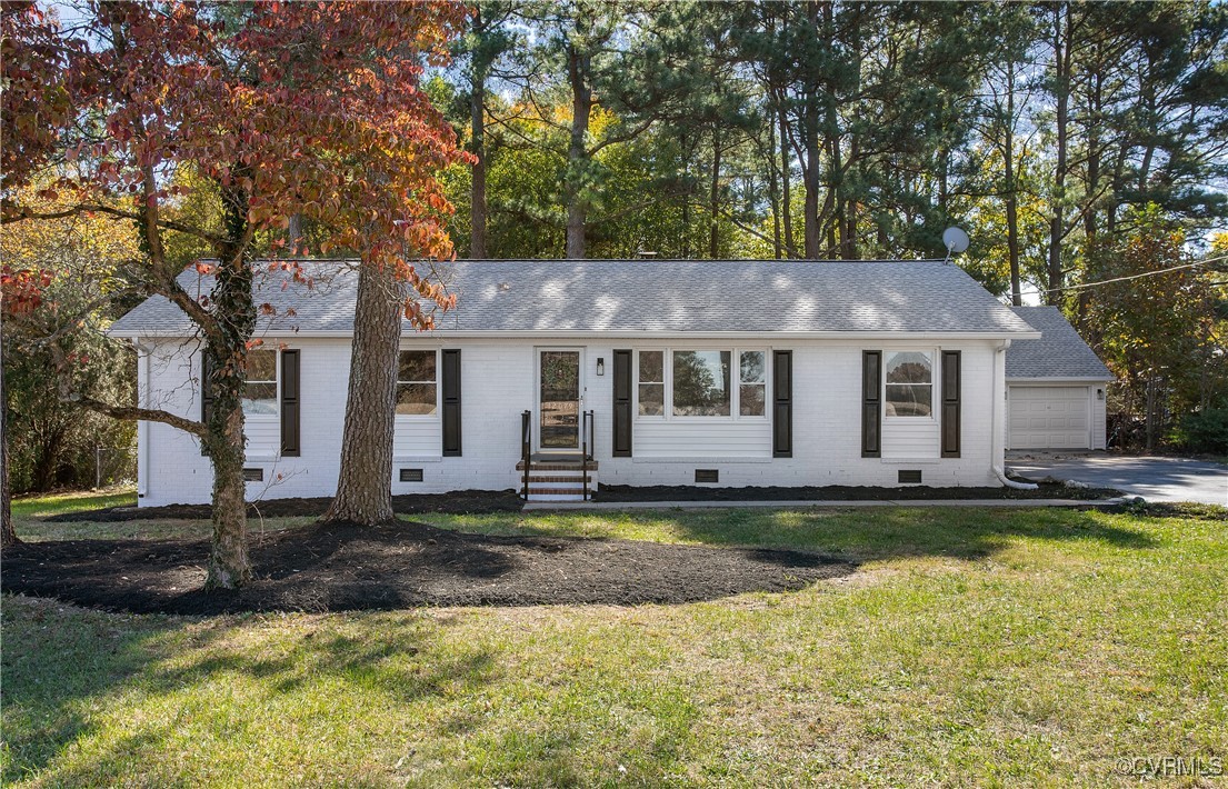 12079 Sunset Drive Ashland, VA 23005 - Photo 2 of 27 a front view of a house with a yard table and chairs