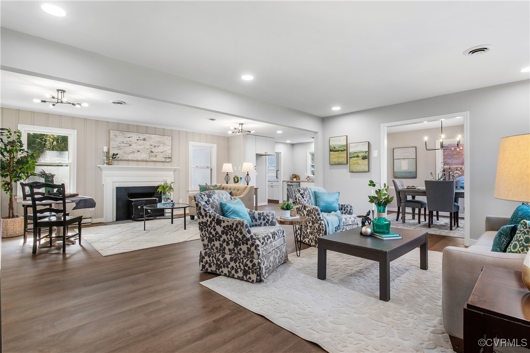 12079 Sunset Drive Ashland, VA 23005 - Photo 4 of 27 a living room with furniture a fireplace and a dining table with wooden floor