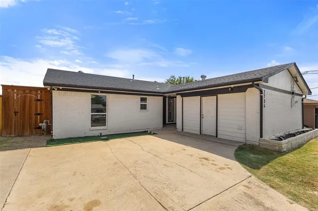 a view of a house with wooden fence