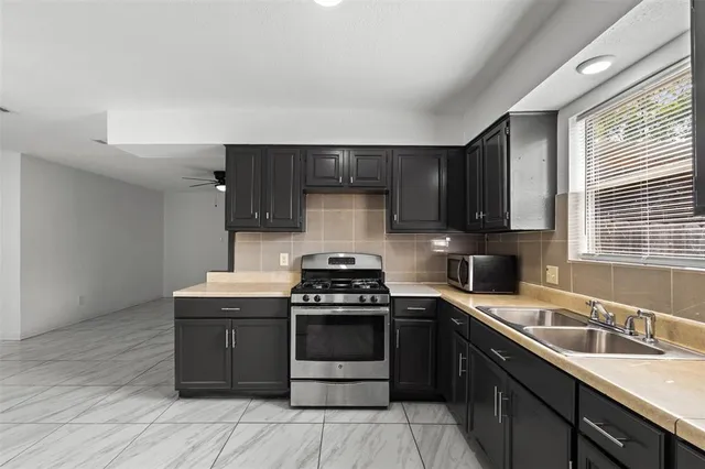 a kitchen with a stove and a sink