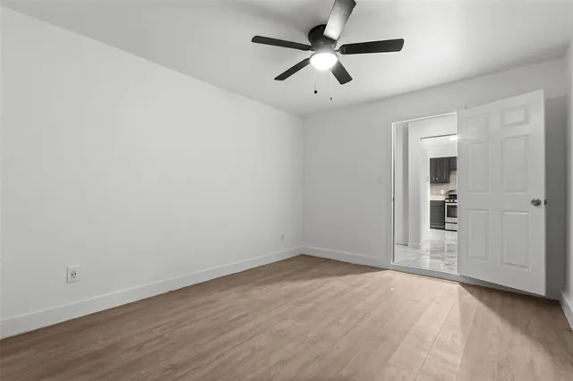 an empty room with a empty space and a ceiling fan