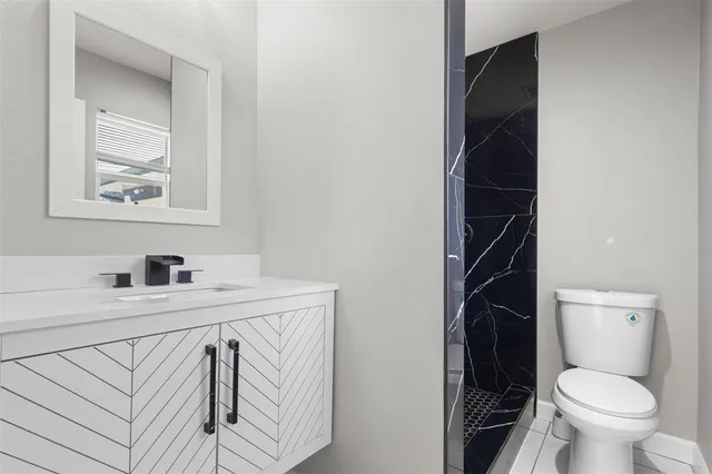 a bathroom with a sink toilet and vanity