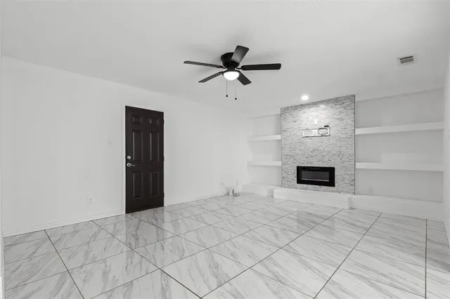 a view of empty room with fireplace