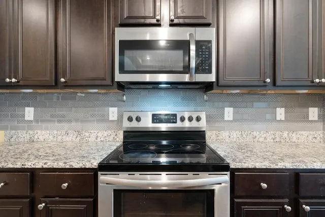 a stove top oven sitting inside of a kitchen