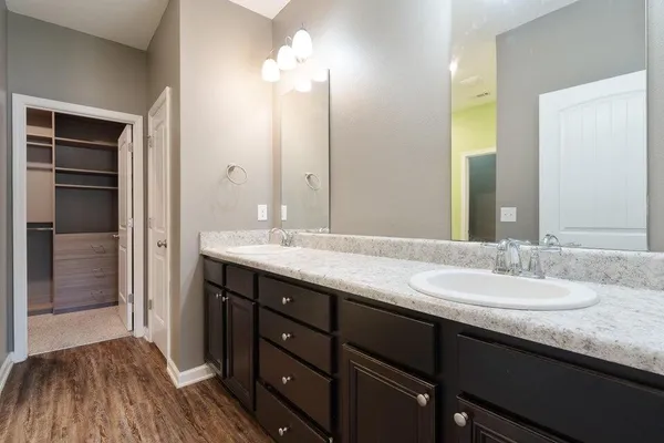 a bathroom with a double vanity sink and a mirror