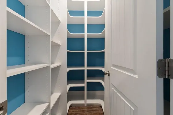 a view of a room with wooden floor