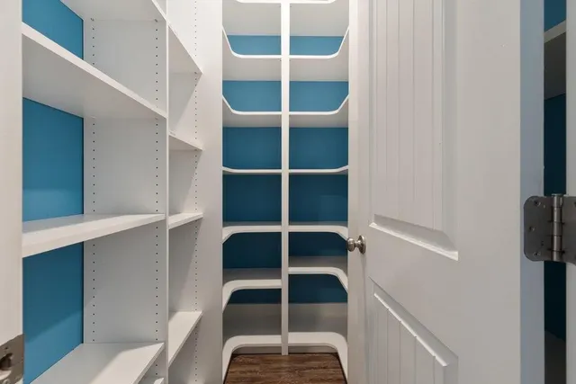 a view of a room with wooden floor