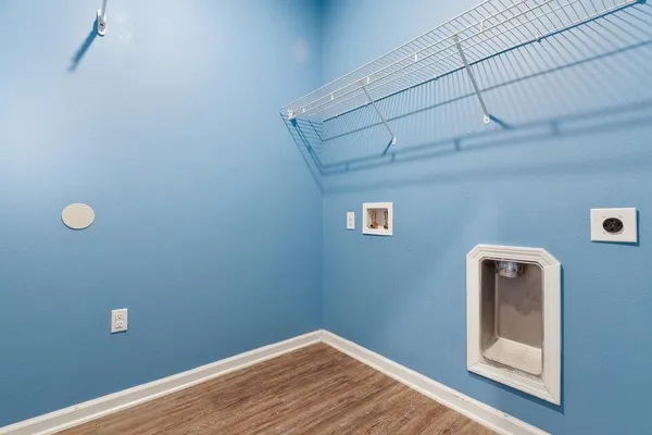 an empty room with windows and chandelier fan