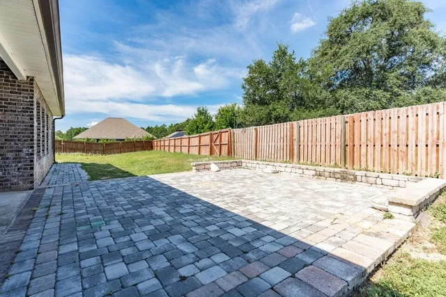 a view of a backyard with sitting area
