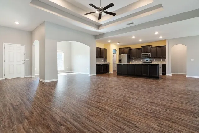 a view of a kitchen with a sink and a large window