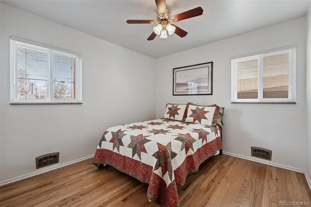 a bedroom with bed and wooden floor