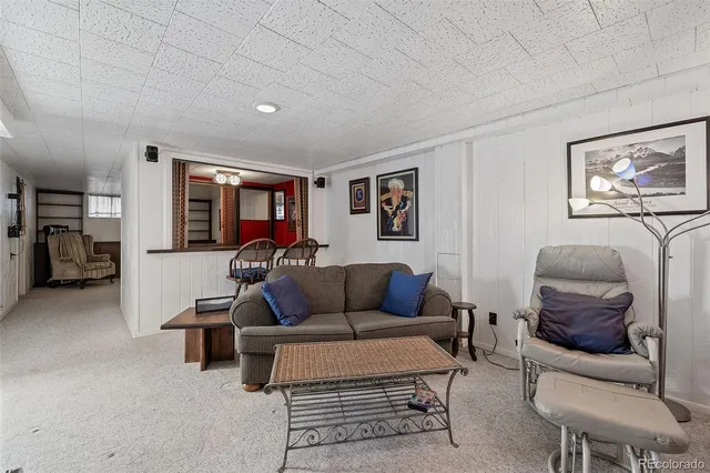 a living room with furniture and a lamp
