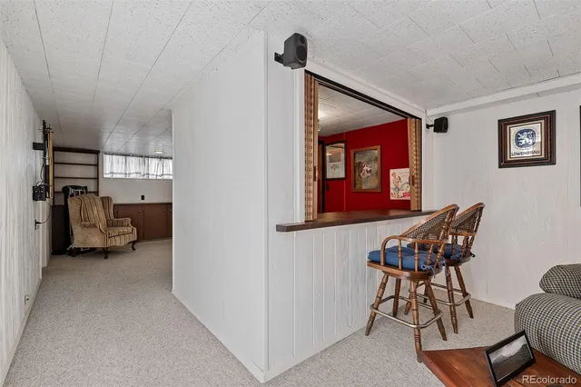 a view of a livingroom with furniture and a hallway