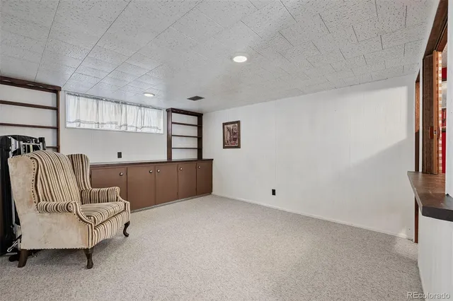 a view of kitchen with furniture and refrigerator