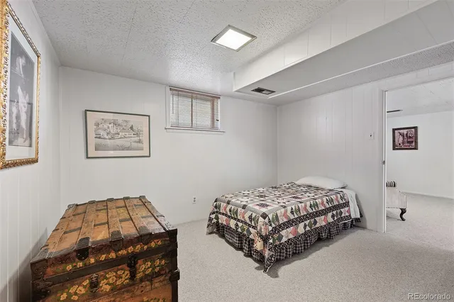 a bedroom with a bed and a mirror