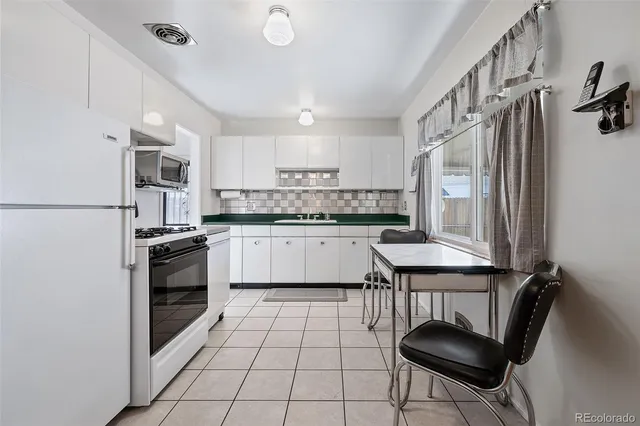 a kitchen with a sink appliances and cabinets