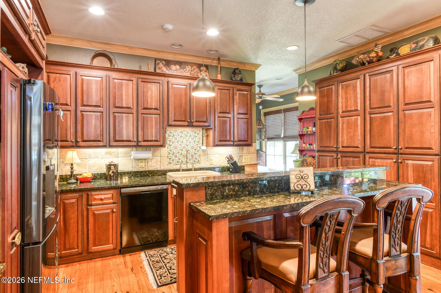 131 Whitney Street Satsuma, FL 32189 - Photo 11 of 75 a kitchen with stainless steel appliances granite countertop a stove a sink and a refrigerator