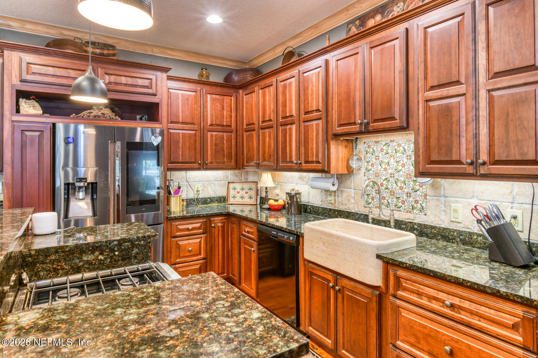131 Whitney Street Satsuma, FL 32189 - Photo 12 of 75 a kitchen with stainless steel appliances granite countertop a sink stove and cabinets