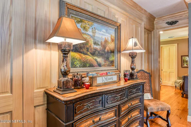 a living room with furniture a chandelier and a dining table