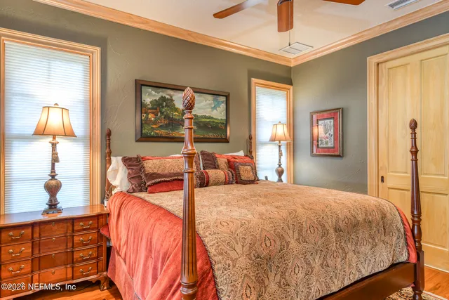 a bedroom with double bed and a window