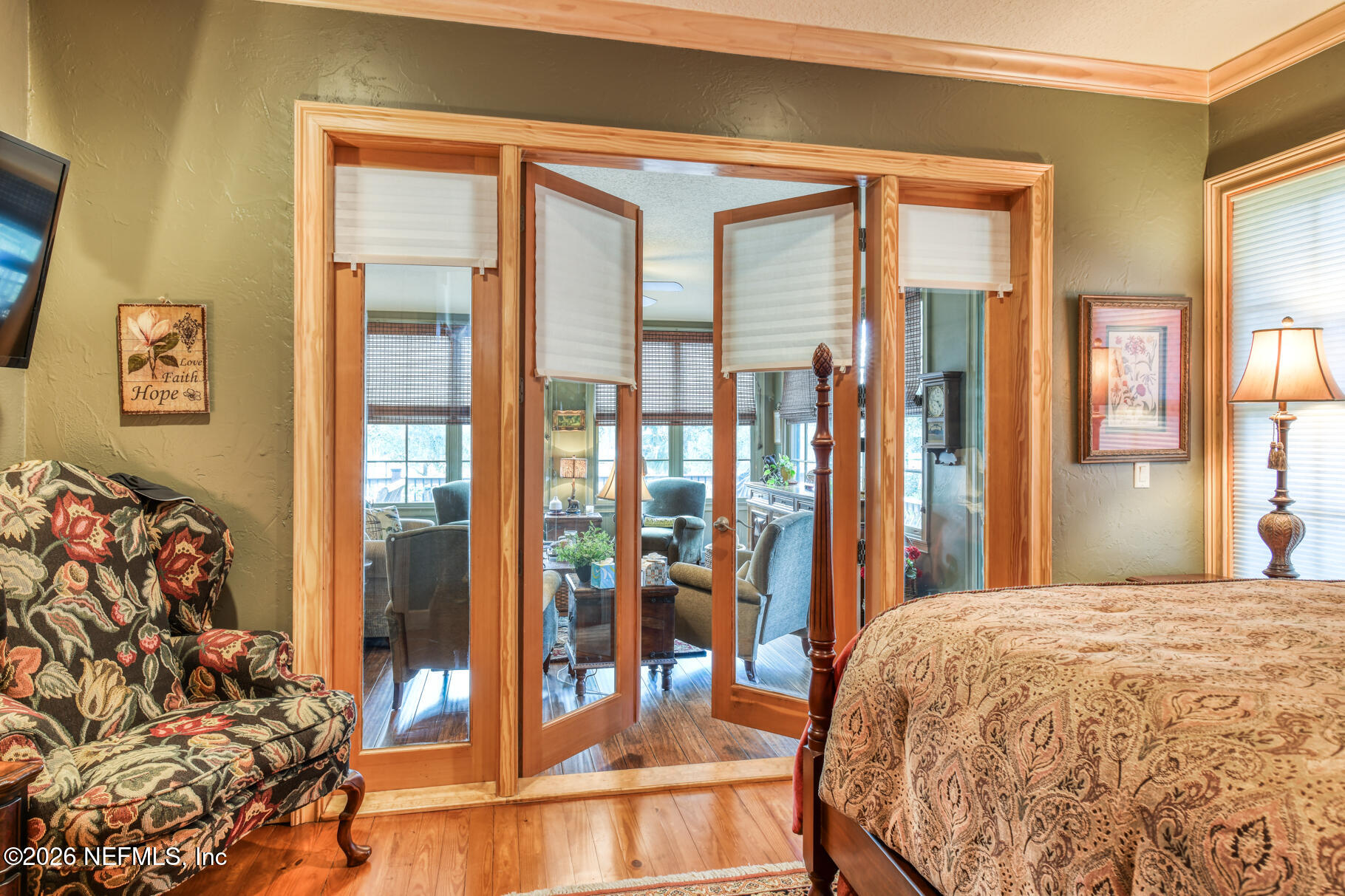 131 Whitney Street Satsuma, FL 32189 - Photo 23 of 75 a bedroom with a bed and a large window with outer view