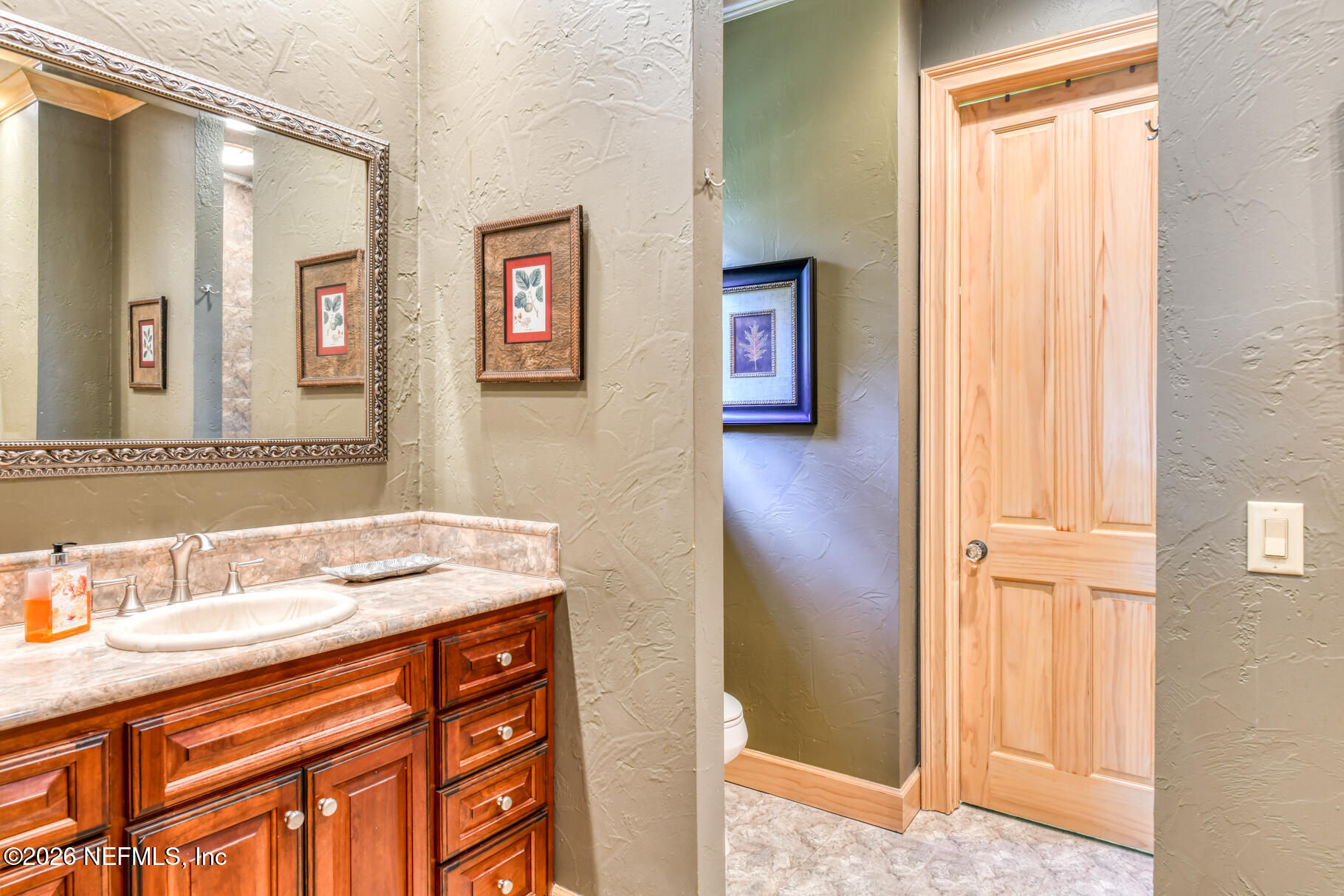131 Whitney Street Satsuma, FL 32189 - Photo 24 of 75 a bathroom with a sink a vanity and a mirror