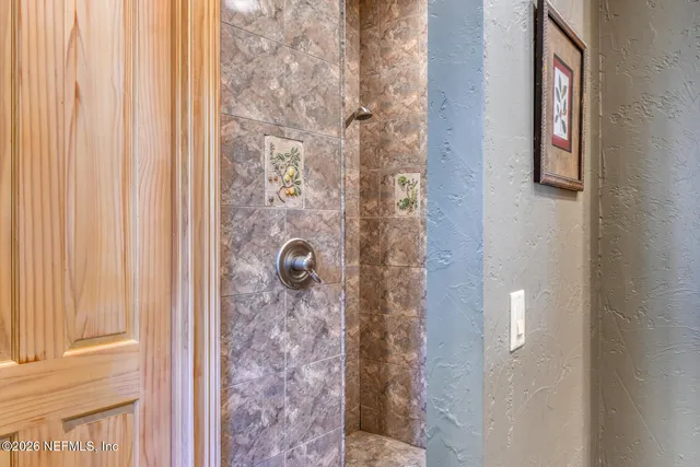 a living room with furniture a flat screen tv and a large window