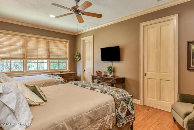 a bedroom with a large bed and a book shelf